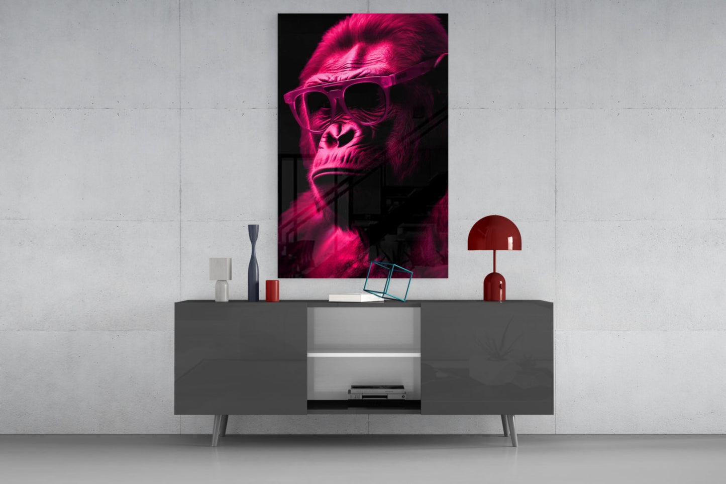 Neon pink glowing gorilla wearing sunglasses displayed as wall art above gray media console with red lamp and decorative objects.