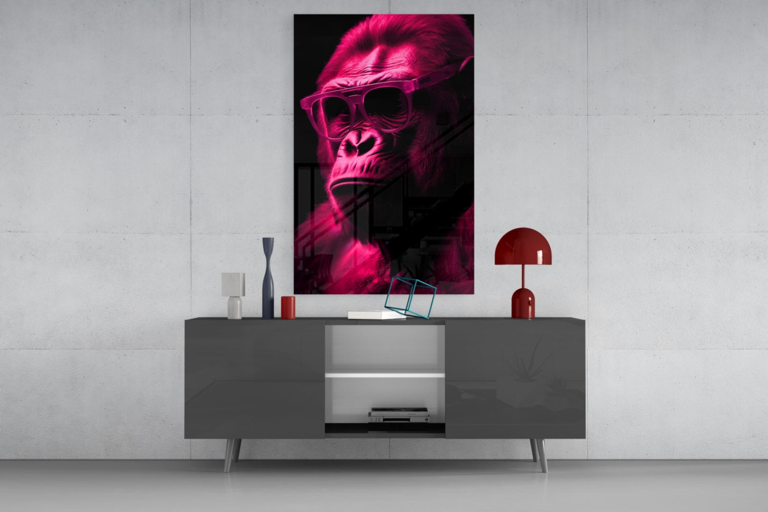 Neon pink glowing gorilla wearing sunglasses displayed as wall art above gray media console with red lamp and decorative objects.