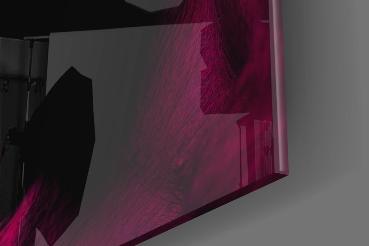 Angled side view of magenta and burgundy glass wall art with textured surface and silhouetted figure, mounted on gray wall.