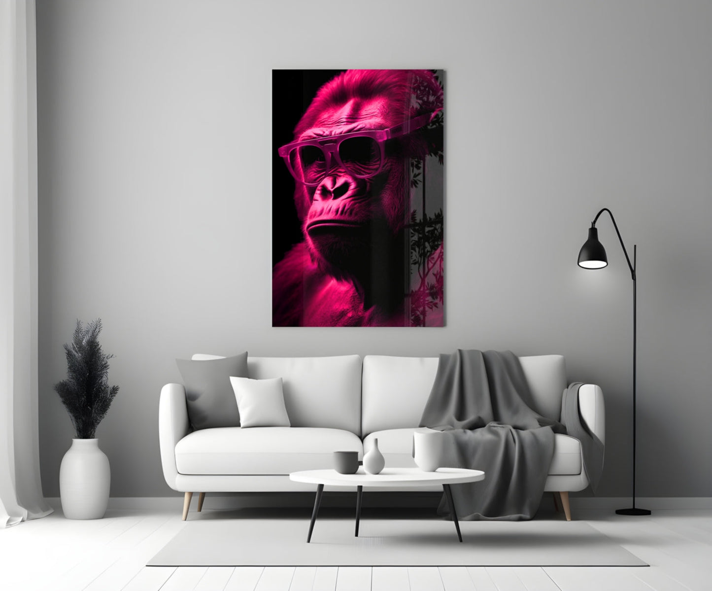 Neon pink gorilla wearing sunglasses displayed on white wall above living room sofa.