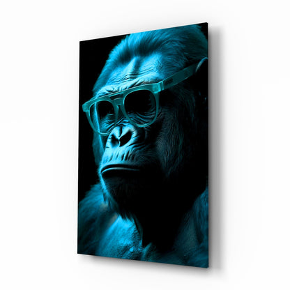 Cool-toned blue-lit gorilla wearing oversized glasses against black background on angled glass panel.