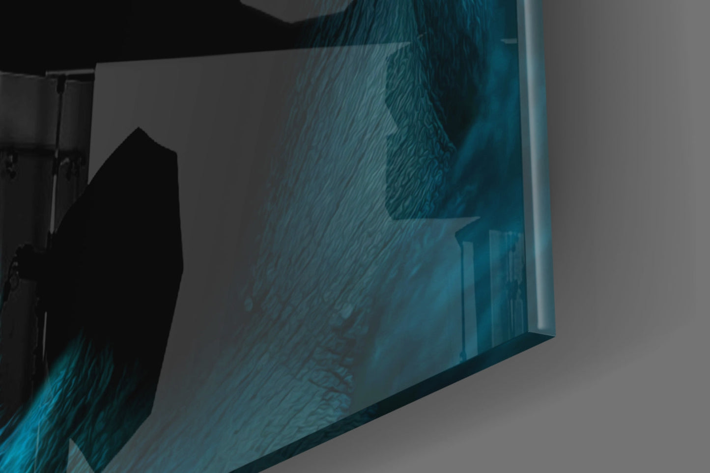 Angled view of glass wall art displaying teal and black silhouette of contemplative ape figure against white background.