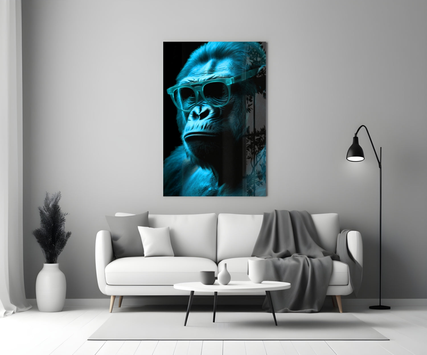 Blue-tinted gorilla wearing sunglasses displayed on white living room wall above gray sofa.
