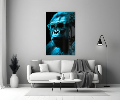 Blue-tinted gorilla wearing sunglasses displayed on white living room wall above gray sofa.