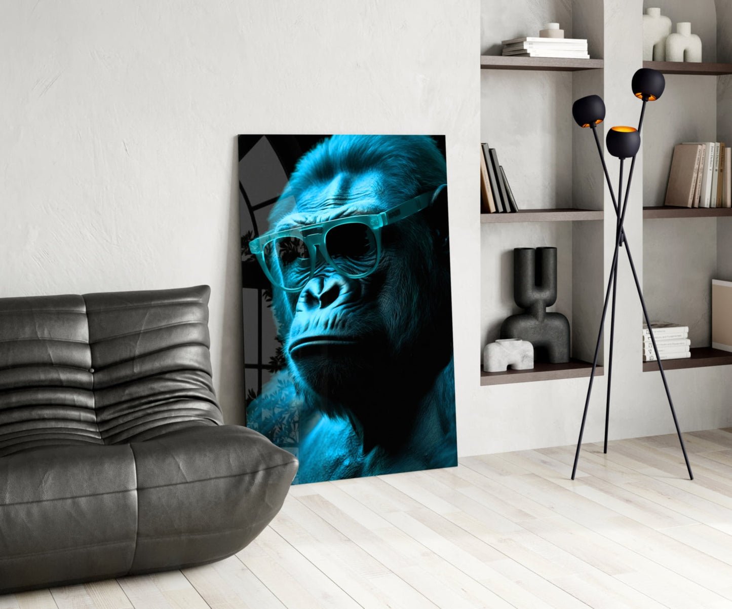 Blue neon gorilla wearing sunglasses displayed as glass wall art in modern living room with gray sofa and shelving.