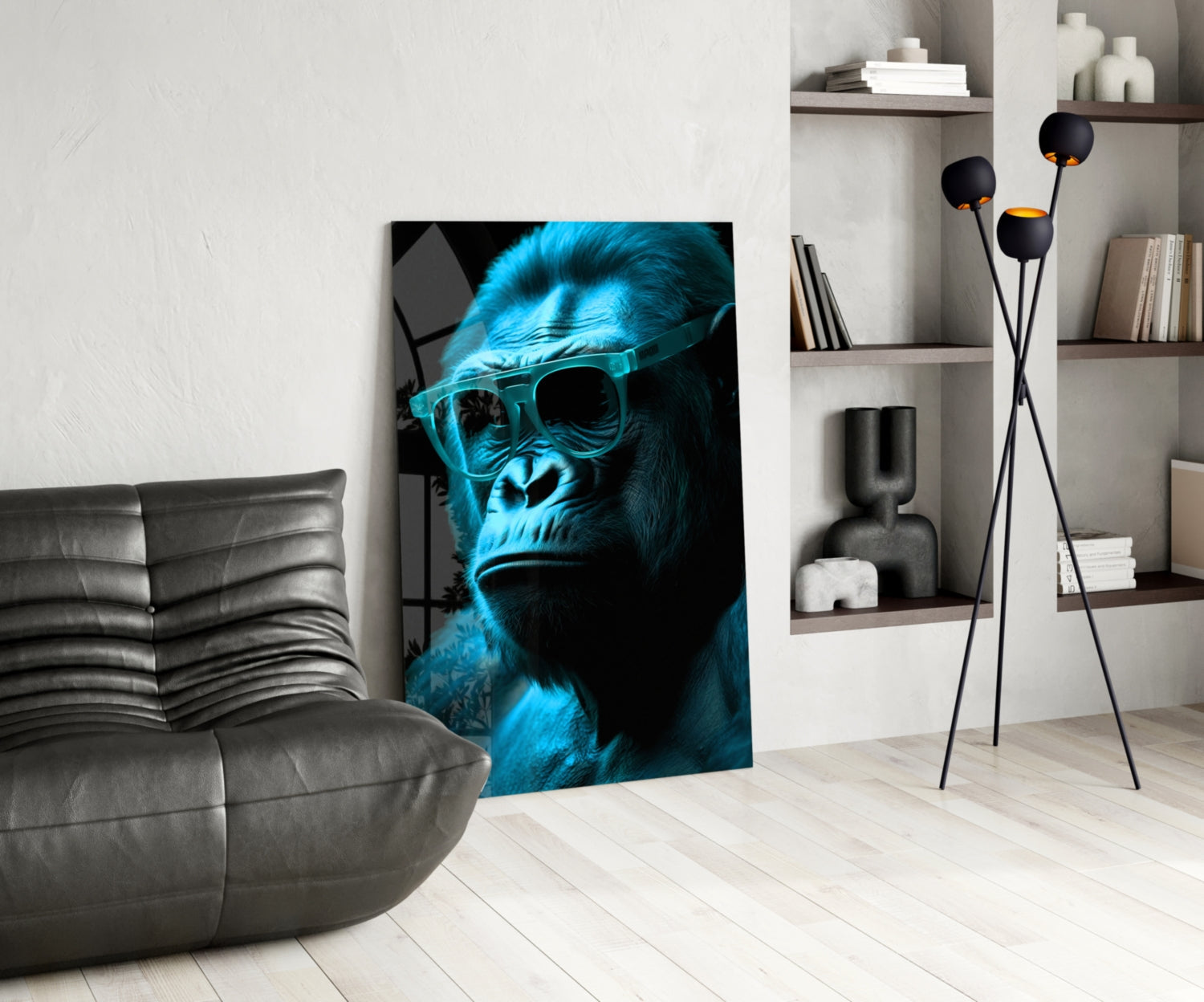 Blue neon gorilla wearing sunglasses displayed as glass wall art in modern living room with gray sofa and shelving.