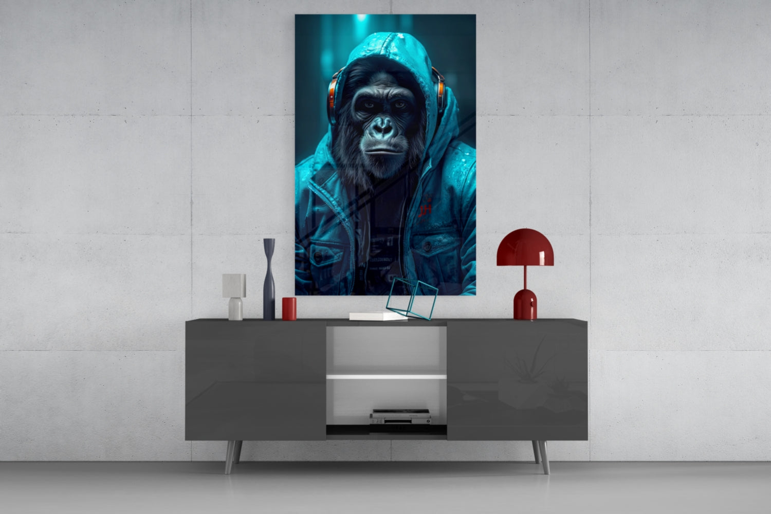 Modern living room display featuring a chimpanzee in blue hoodie and headphones glass art above a gray console table with red lamp.