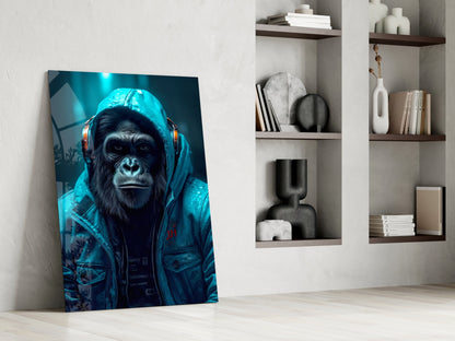 Glass wall art leaning against white wall displays a chimpanzee wearing blue headphones and jacket against teal background.