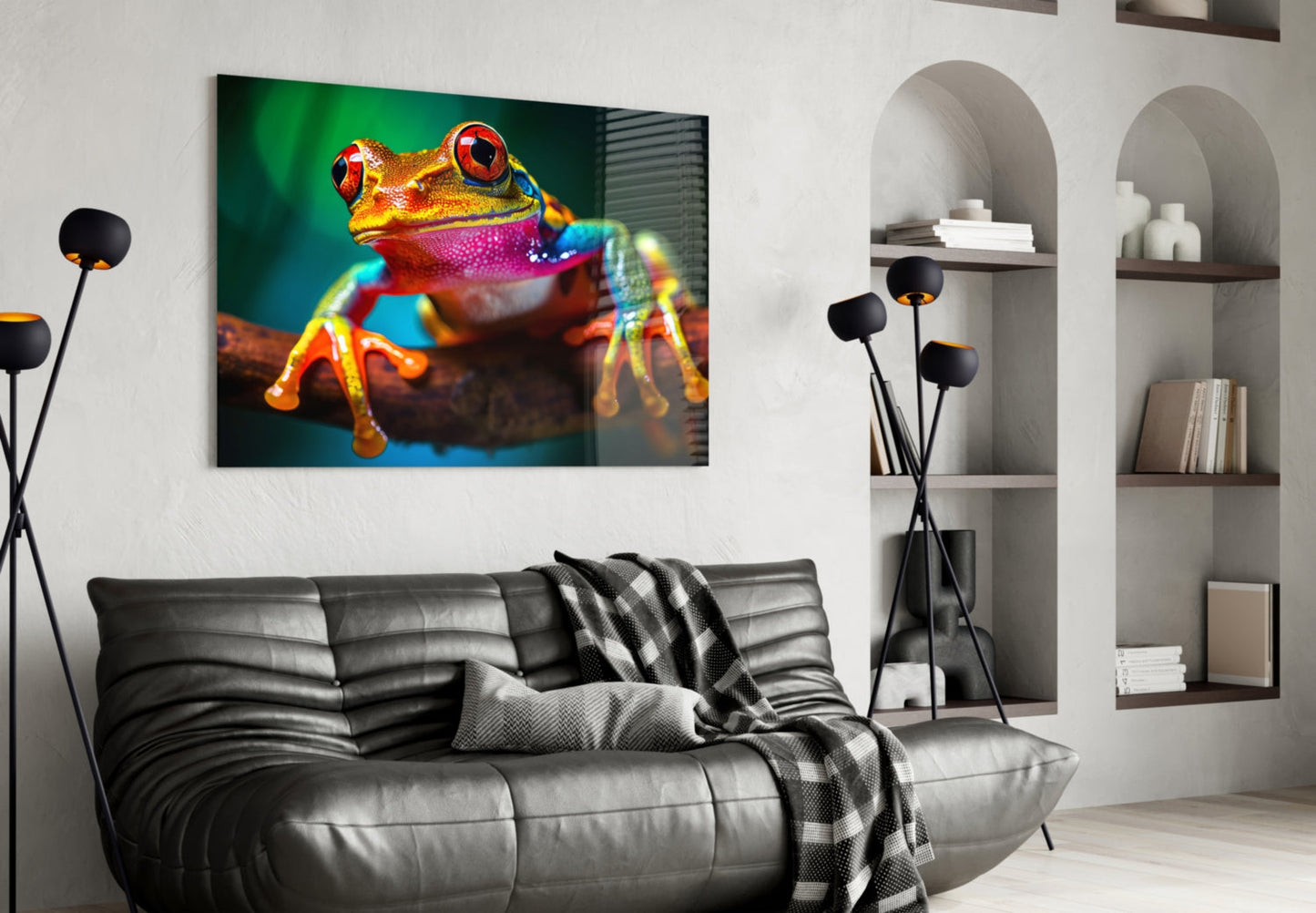 Colorful froglet glass wall art featuring a red and gold frog with vibrant blue and purple accents displayed above a dark leather sofa in a modern living room.