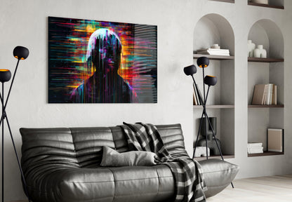 Colorful digital art glass panel depicting an abstract figure with neon pink, yellow, and cyan glitch effects hanging above a black leather sofa in a modern living room.
