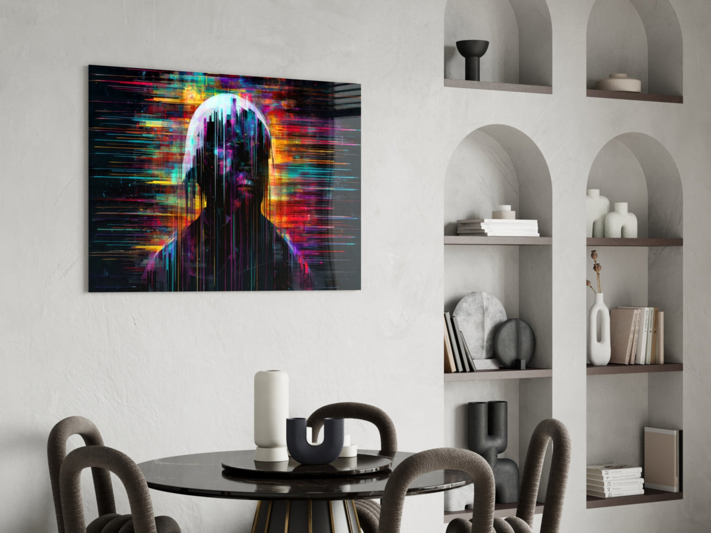 Colorful glitch-effect portrait artwork displayed above round black dining table in modern interior with white built-in shelving.