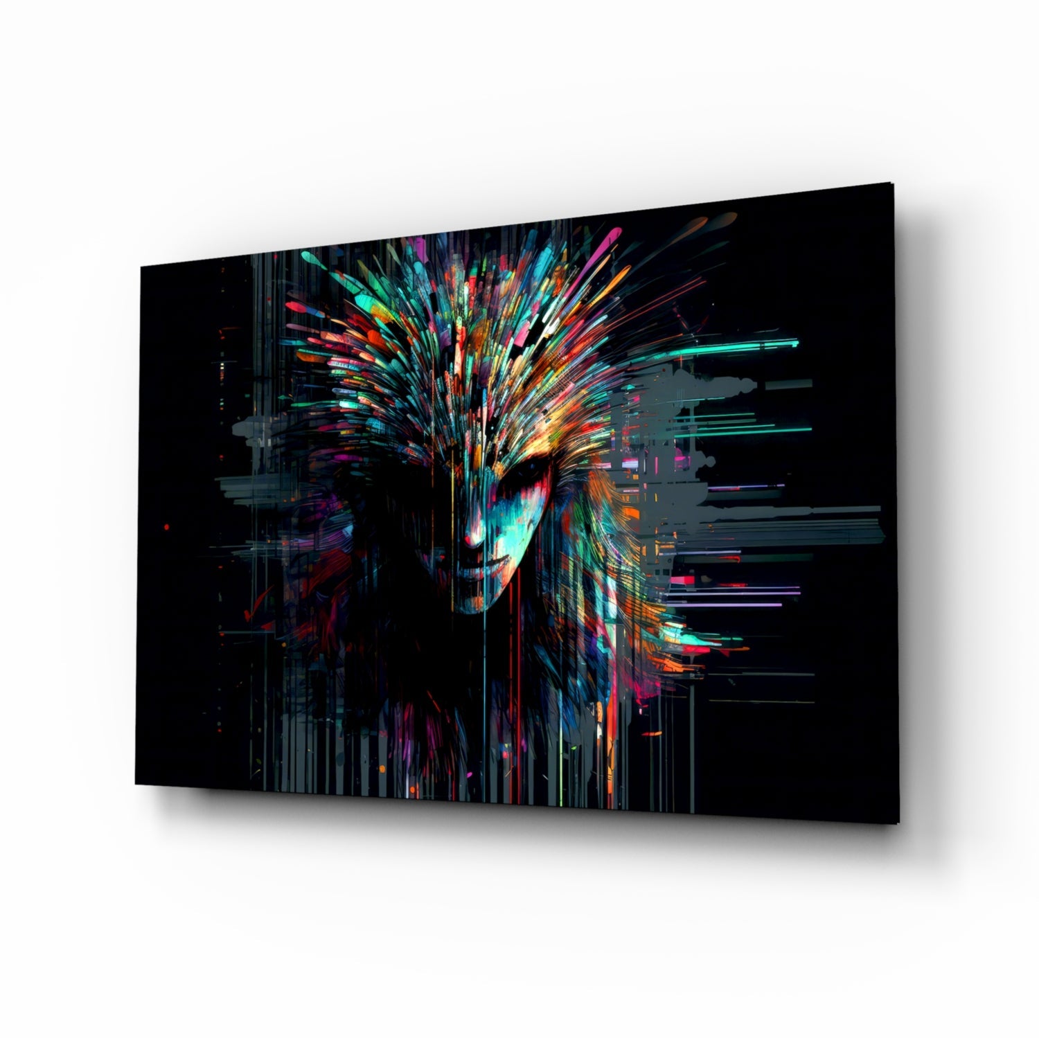Angled view of glass wall art displaying an abstract colorful face with radiating neon streaks in cyan, magenta, orange, and yellow against black background.