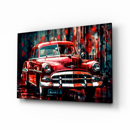 Red vintage 1950s American car displayed front-facing on glass wall art with distressed urban background.