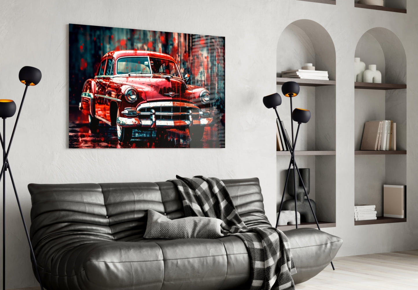 Vintage red American car glass wall art displayed above a black leather sofa in a modern living room with white shelving.