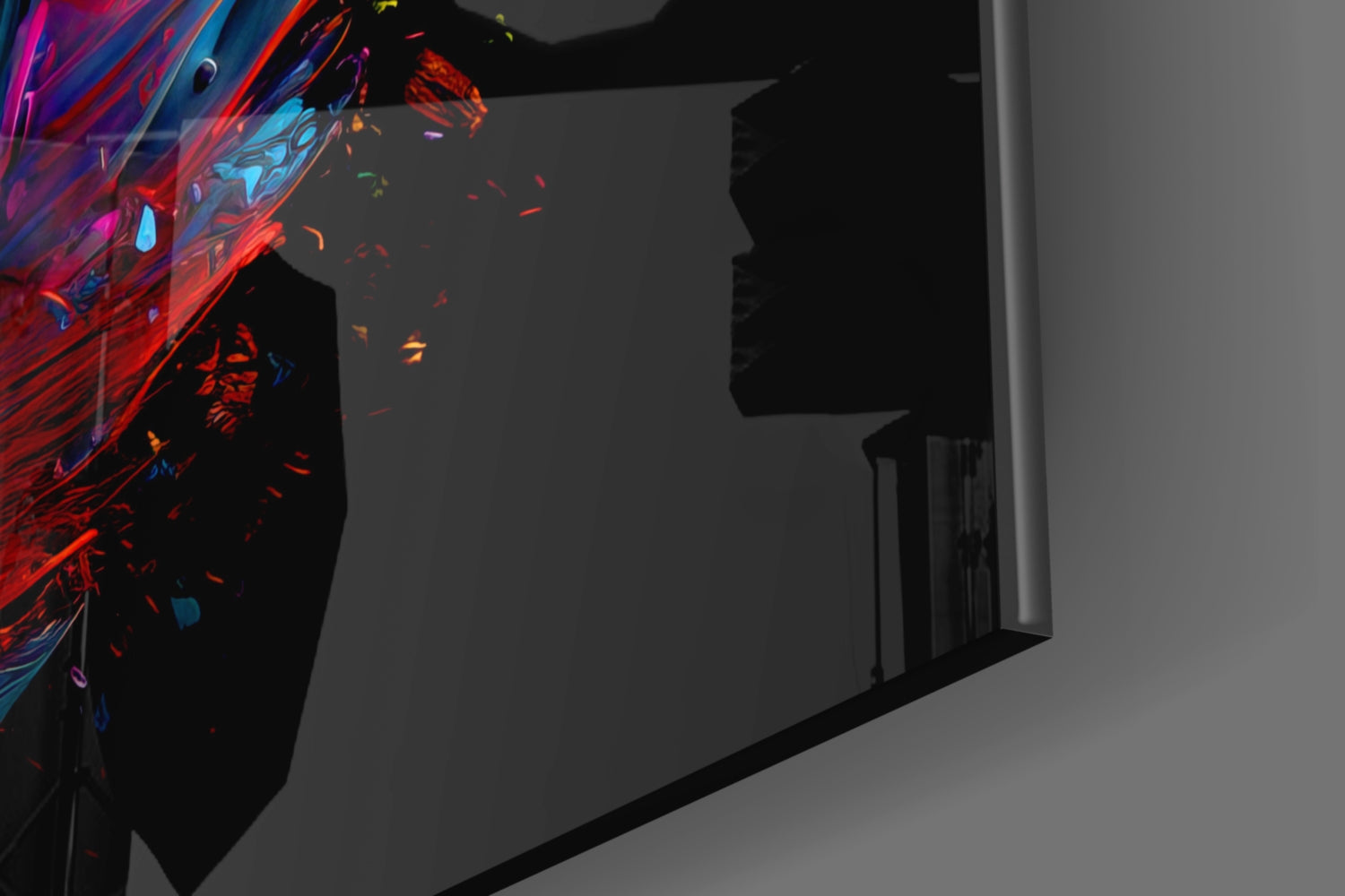Vibrant red and blue feather glass wall art installed on dark interior wall beside doorway, displaying dynamic color gradient.