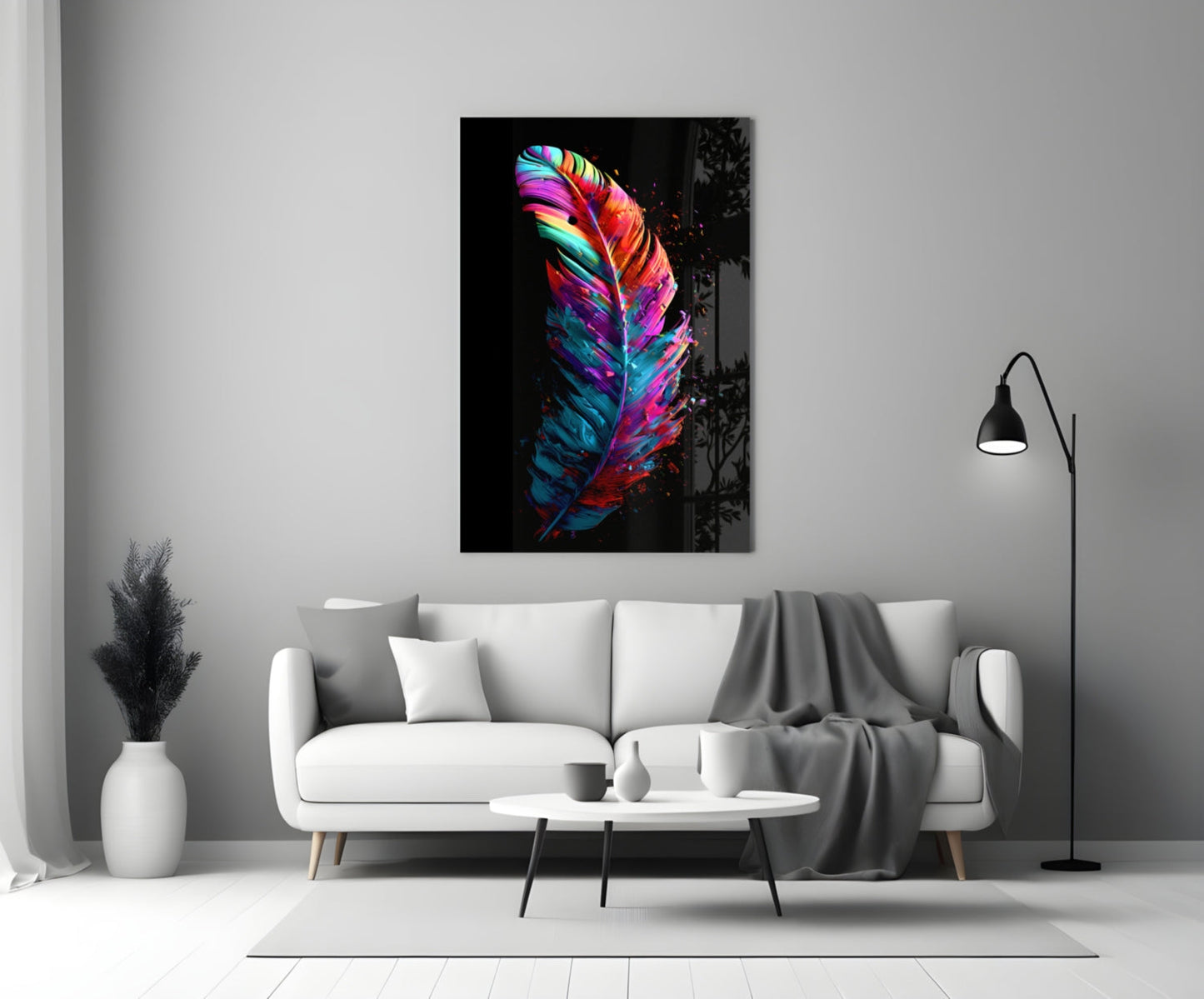 Vibrant multicolored feather glass wall art with neon pink, blue, and yellow stripes hanging above a white sofa in a minimalist living room.