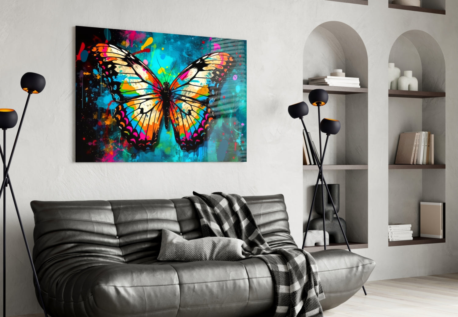 Colorful butterfly glass wall art hanging above black leather sofa in modern living room with white shelving.