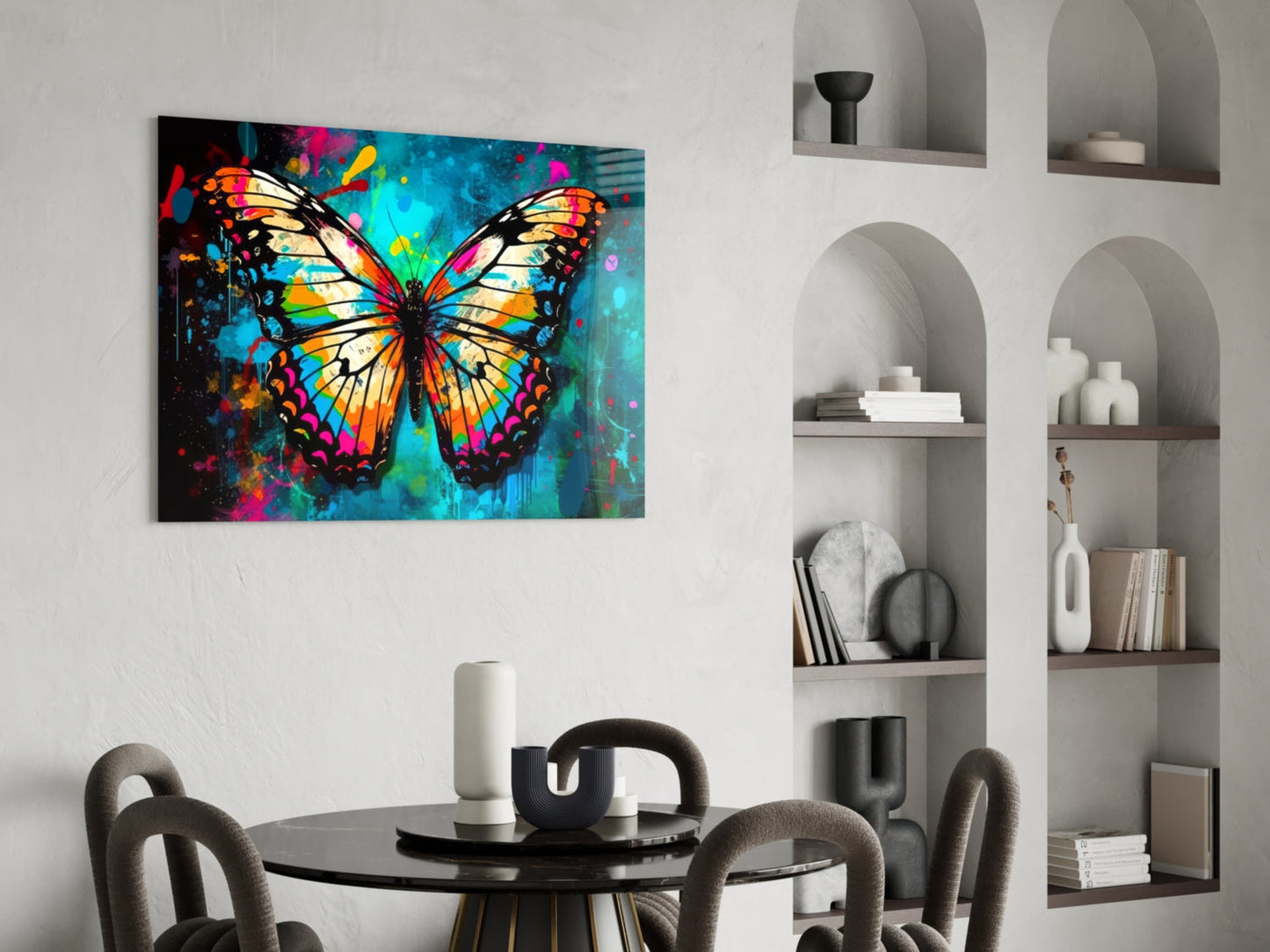 Colorful glass wall art featuring a vibrant butterfly with orange, yellow, and turquoise wings displayed above a dining table in a modern interior.