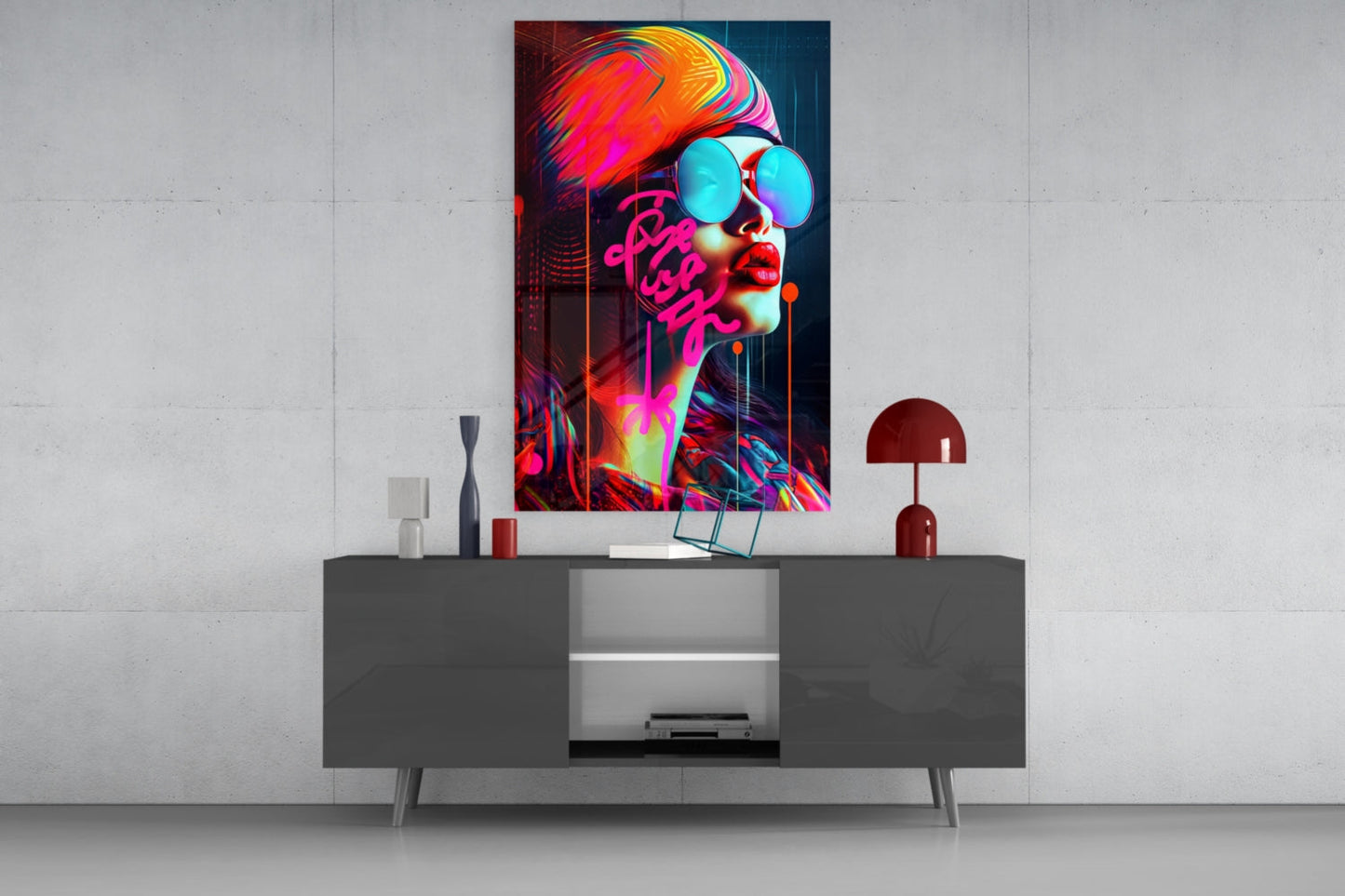 Vibrant neon pop art glass wall art featuring a figure with cyan sunglasses and magenta text displayed above a dark console table.