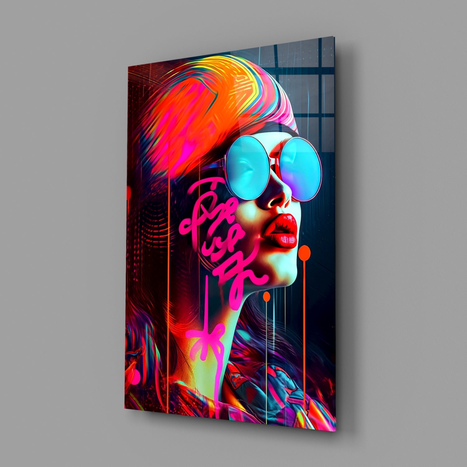 Angled view of colorful glass wall art featuring a profile portrait with neon pink text, cyan sunglasses, and vibrant rainbow hair against dark background.
