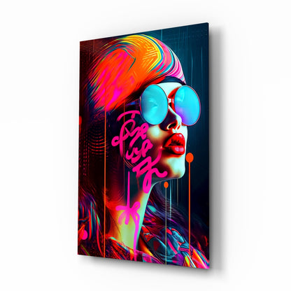 Angled view of vibrant neon glass wall art featuring a profile portrait with colorful hair, cyan sunglasses, and magenta typography against dark background.
