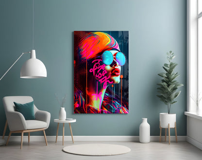 Vibrant neon glass wall art depicting a stylized face with cyan sunglasses and multicolored hair in modern interior setting.