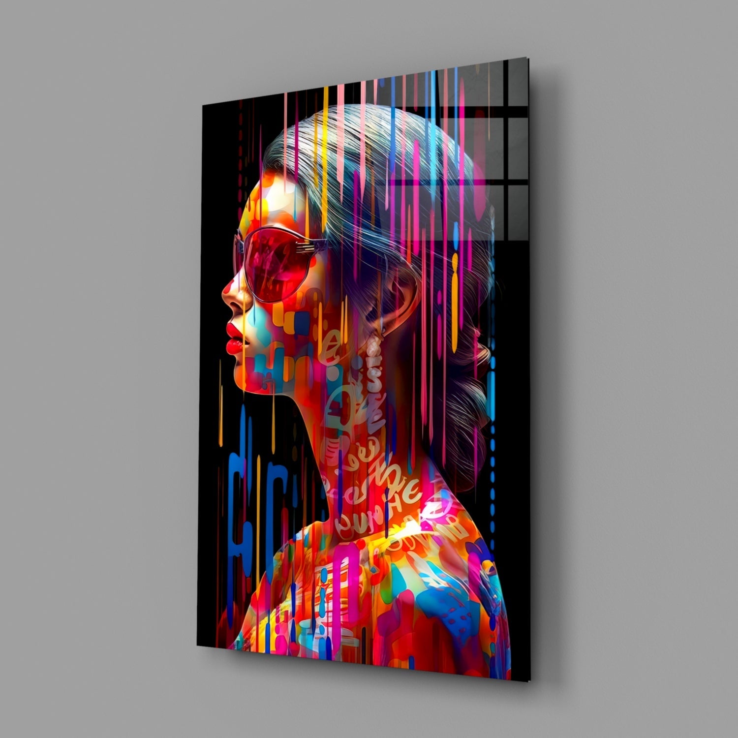 Angled side view of glass wall art displaying a colorful portrait with neon stripes, vibrant text overlays, and geometric patterns on black background.