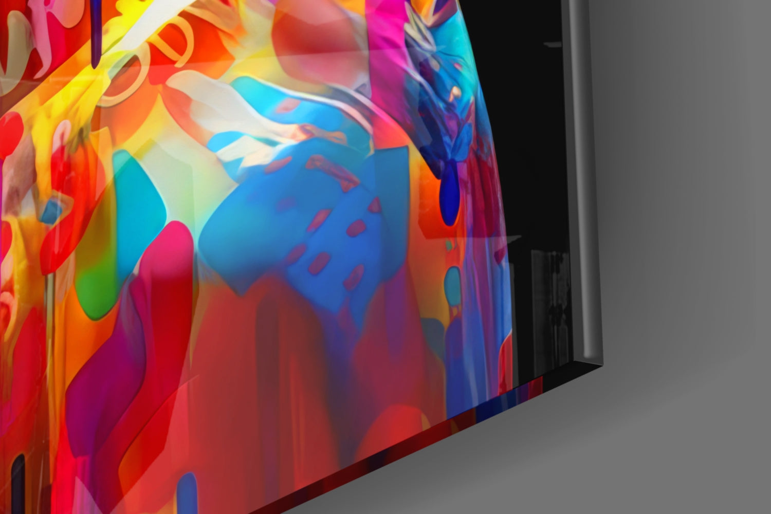 Angled close-up view of vibrant multicolored glass wall art featuring layered abstract shapes in red, blue, yellow, pink, and green hues.