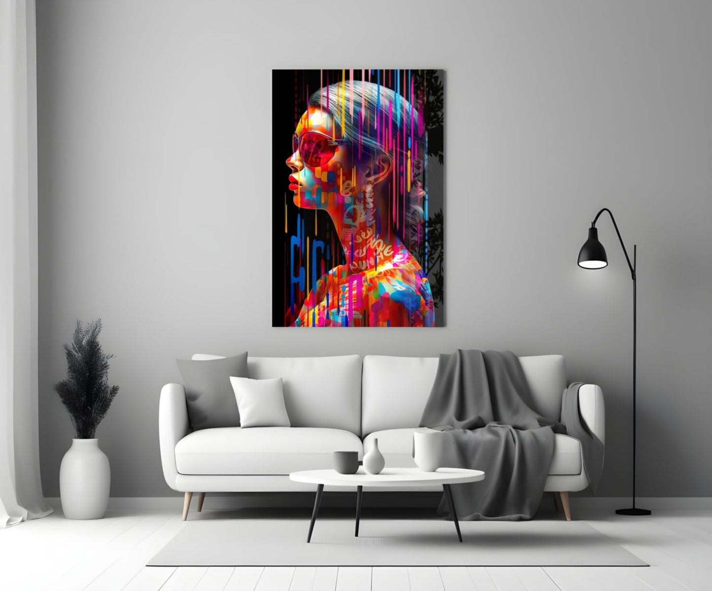 Colorful neon-style glass wall art depicting a profile portrait with rainbow stripes displayed above a white sofa in a minimalist living room.
