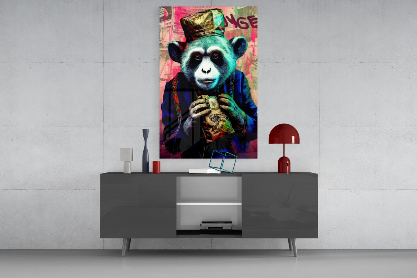 Colorful pop art glass wall art of a chimp wearing a crown and holding a heart, displayed above a modern gray sideboard in a minimalist interior.