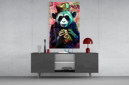 Colorful pop art glass wall art of a chimp wearing a crown and holding a heart, displayed above a modern gray sideboard in a minimalist interior.