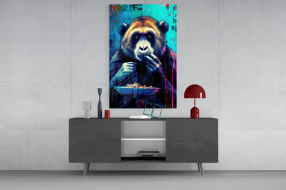 Vibrant pop art glass wall panel featuring a colorful chimpanzee with cyan and magenta tones, displayed above a gray console table with red lamp.