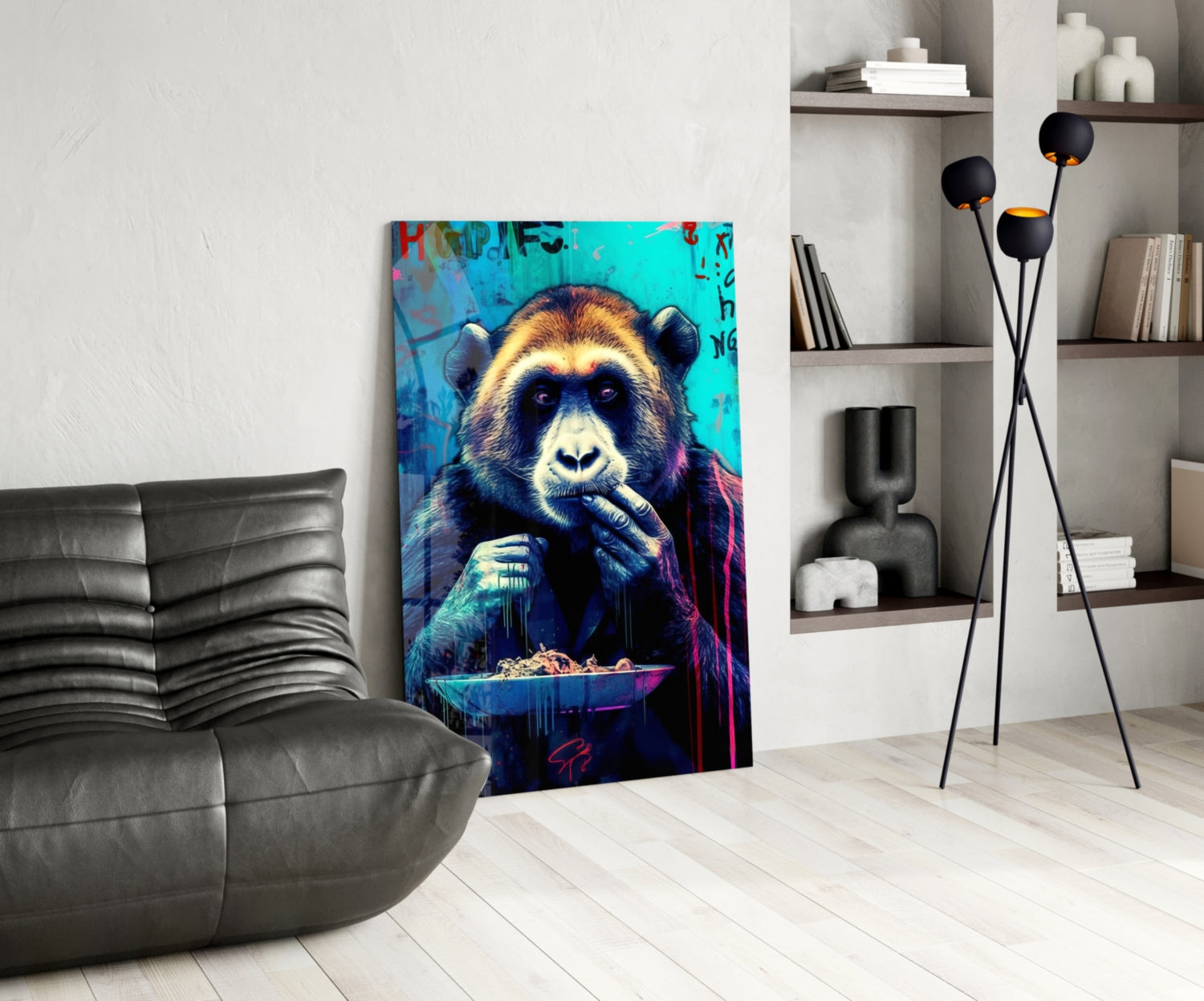 Vibrant glass wall art depicting a colorful chimpanzee with turquoise, gold, and purple tones against a blue background, displayed in a modern living room beside a gray sofa.