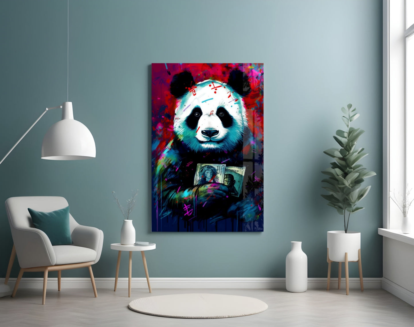 Colorful pop art panda holding dollar bills displayed on teal wall above white chair and potted plant.