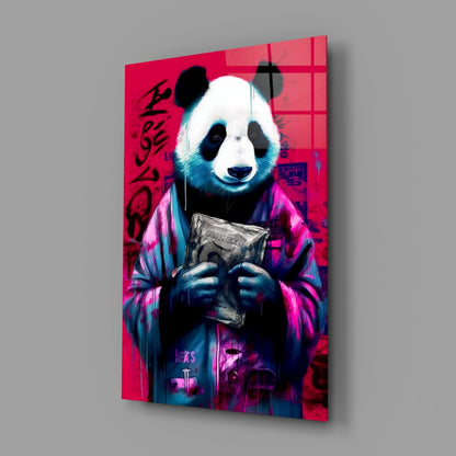 Angled view of glass wall art depicting a stylized panda holding currency against vibrant pink, blue, and magenta background with graffiti elements.