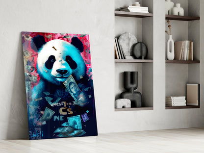 Colorful panda glass art leaning against white wall beside shelving unit, featuring neon pink and blue tones with dollar bills and text.