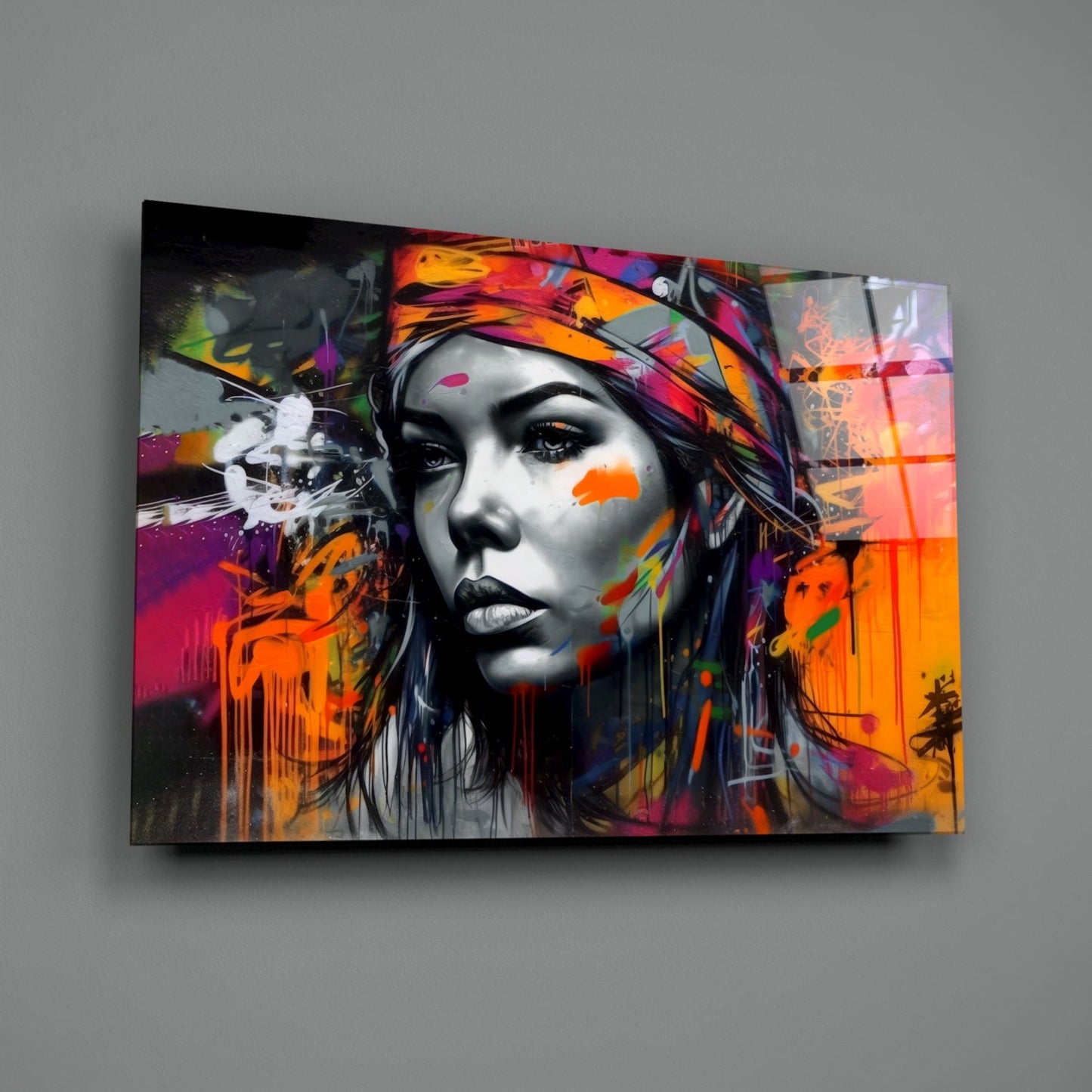 Colorful street art-style glass wall panel featuring a grayscale female face with vibrant rainbow graffiti and splatter effects displayed on gray wall.