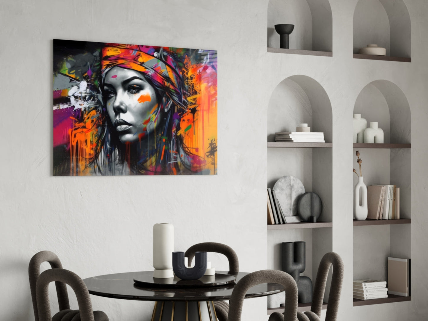 Colorful pop art portrait with black and white face and vibrant orange, pink, and purple paint splatters displayed above a dining table.