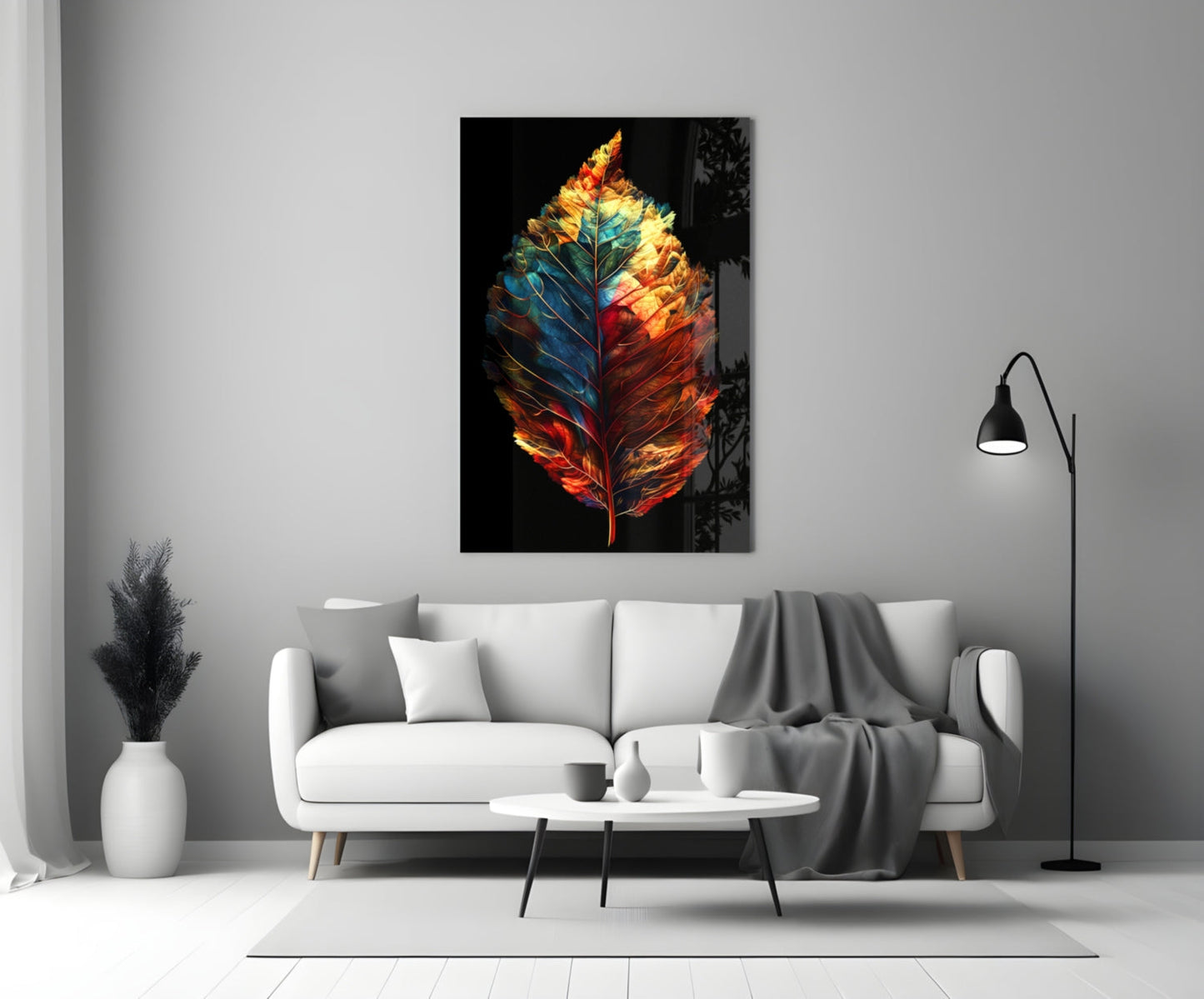 Colorful glass feather wall art with red, orange, yellow, and blue tones displayed above a white sofa in a modern living room.