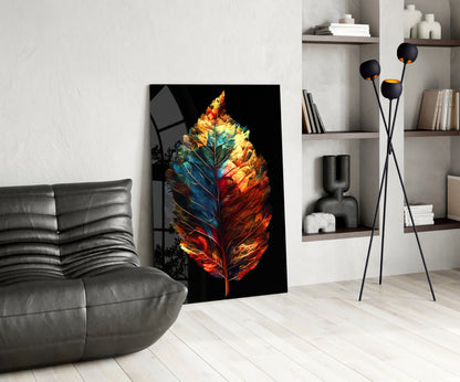 Colorful glass leaf artwork with red, orange, yellow, and blue tones leaning against wall in modern living room interior.
