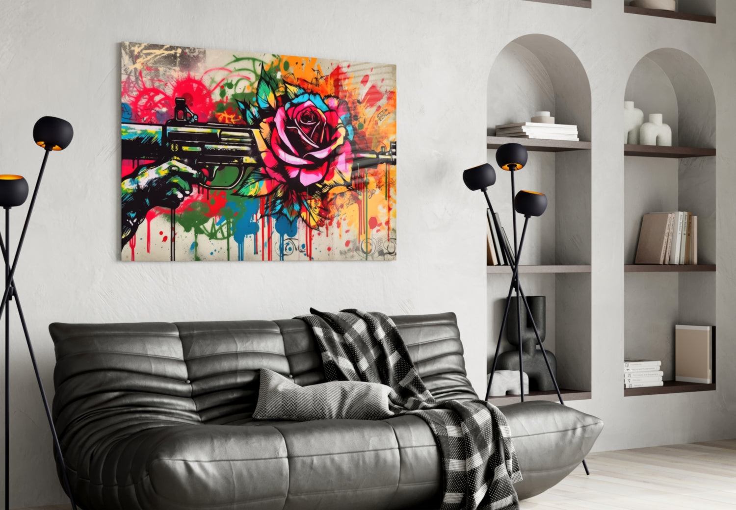 Vibrant pop art canvas depicting colorful roses and a gun with paint drips, hung above a black leather sofa in a modern living room.