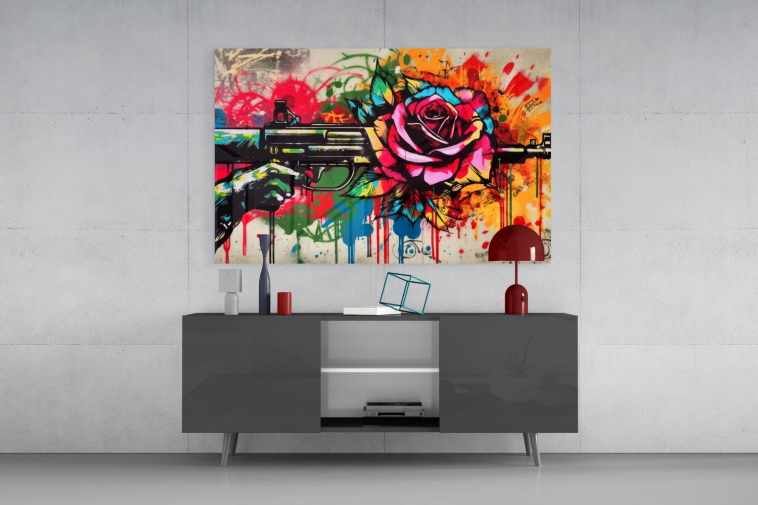 Vibrant pop art glass wall art depicting colorful flowers and a gun mounted above a dark gray media console in a modern interior setting.