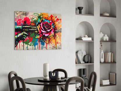 Vibrant street art canvas featuring colorful roses and a revolver displayed above a round black dining table with gray chairs.