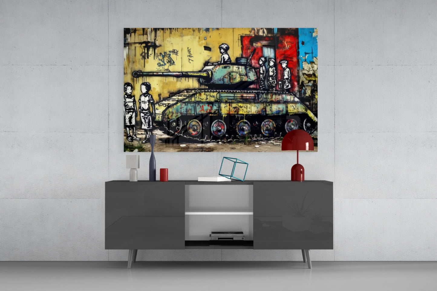 A framed street art print depicting a colorful military tank with children figures displayed above a dark gray media console in a modern interior setting.