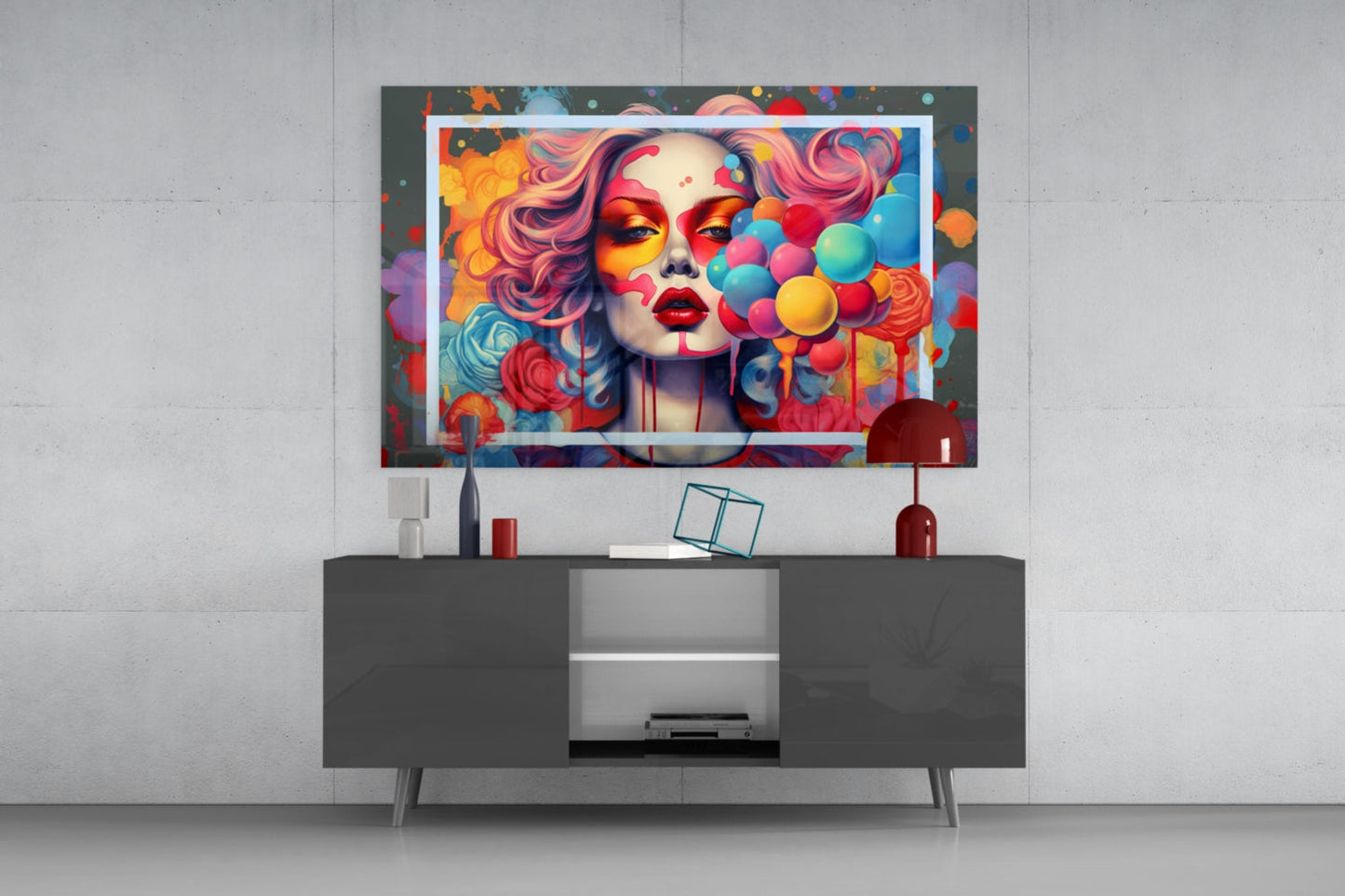 Colorful pop art glass wall art featuring a woman's face with vibrant makeup and balloon motifs displayed above a dark media console.