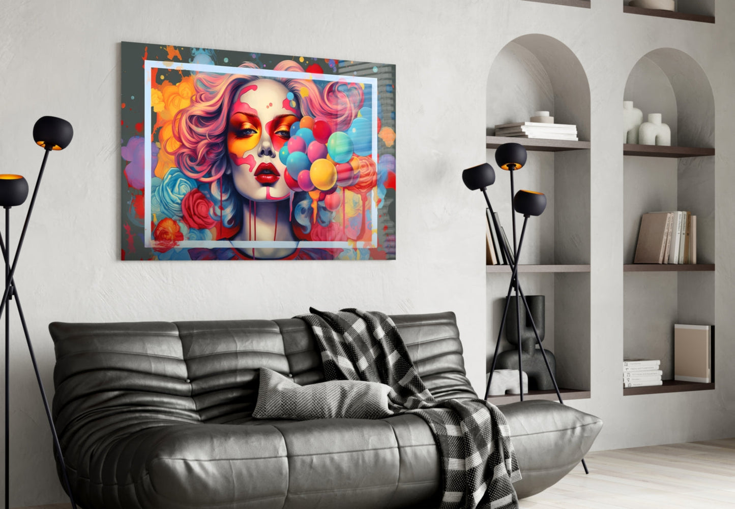 Colorful pop art portrait with vibrant hair and floating balloons displayed above black leather sofa in modern living room.
