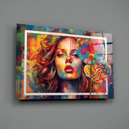 Vibrant glass wall art displaying colorful portrait of woman with red lips against multicolored abstract background, mounted on gray wall.