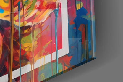Colorful layered glass panels with abstract floral and geometric designs in red, yellow, blue, and green, photographed at an angle showing depth and transparency.