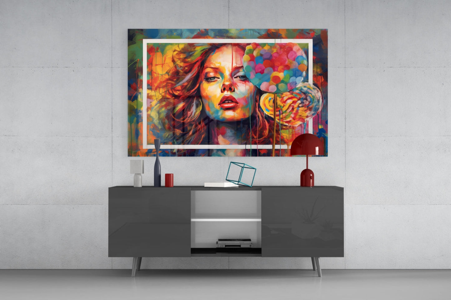 Vibrant pop art glass wall panel featuring a colorful portrait of a woman blowing a lollipop, displayed above a dark console table in a modern interior setting.