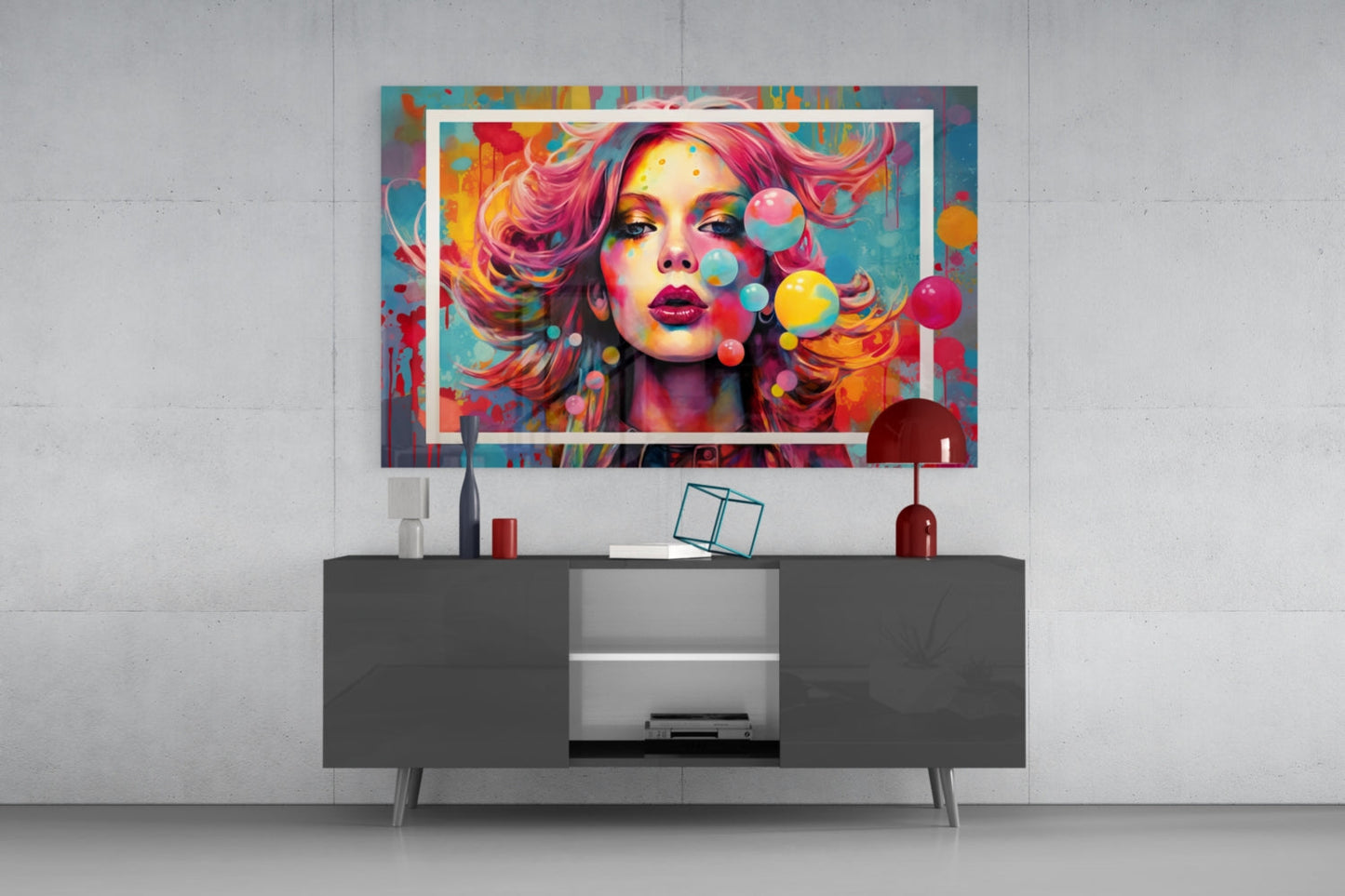Colorful pop art portrait with vibrant pink hair and floating spheres displayed on dark media console in modern living room setting.